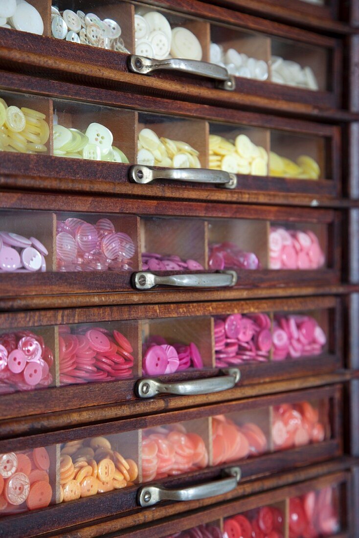 Drawers with transparent fronts and view of colourful buttons