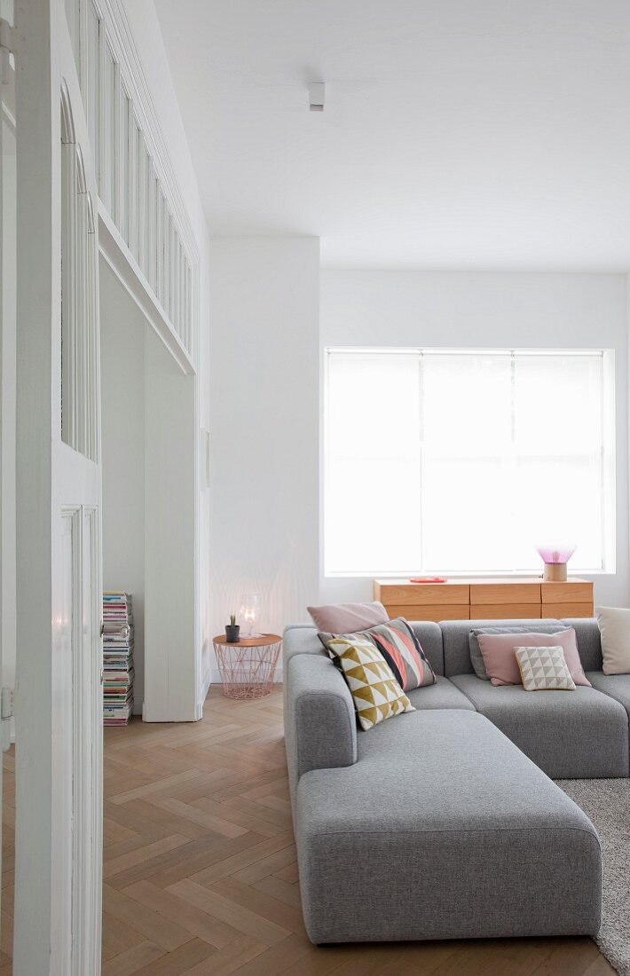 Simple grey sofa combination on herringbone parquet in renovated period building