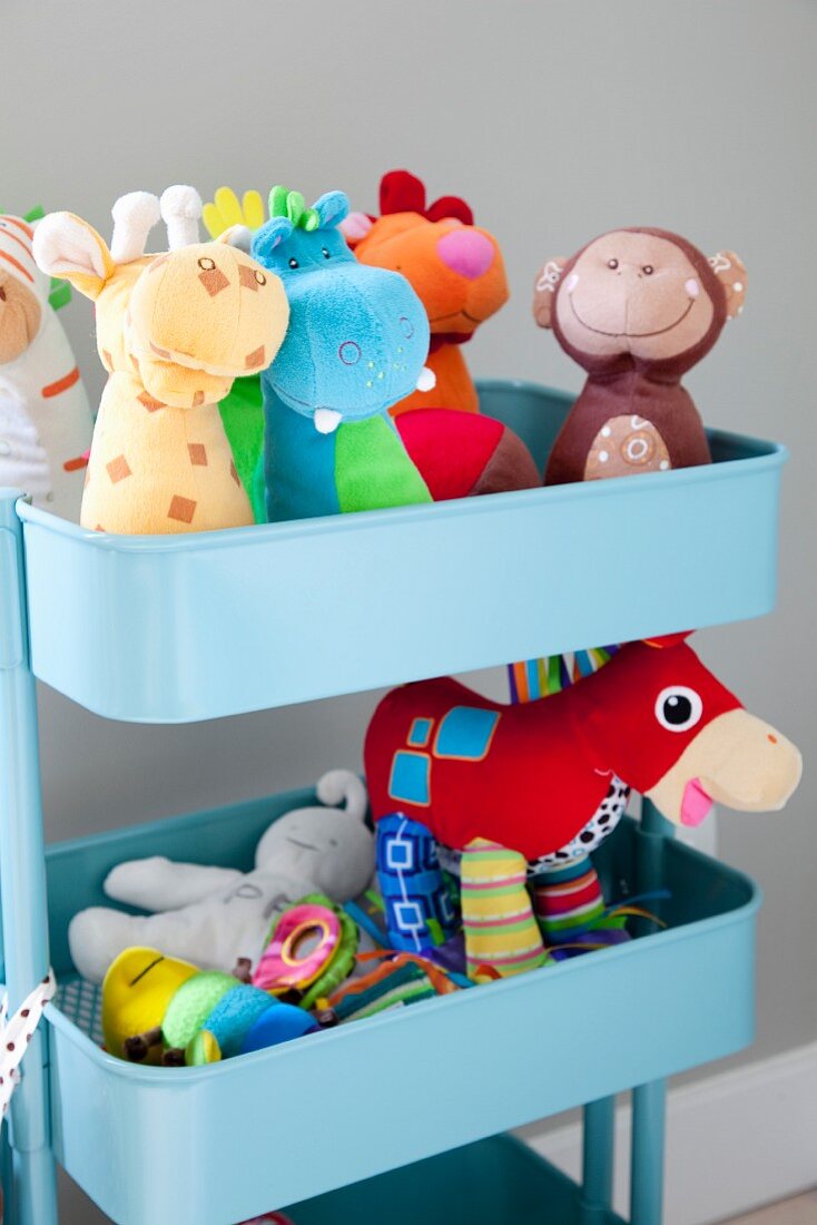 Colourful soft toys on pale blue plastic shelves