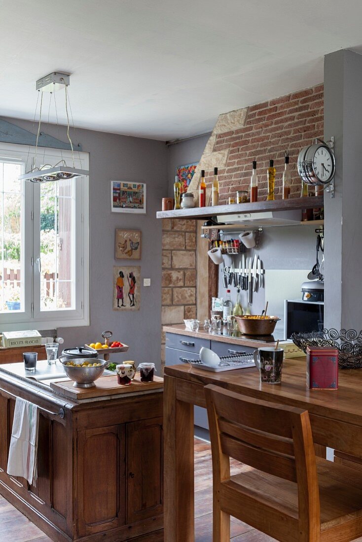 Open-plan country-house kitchen with dining area in restored interior
