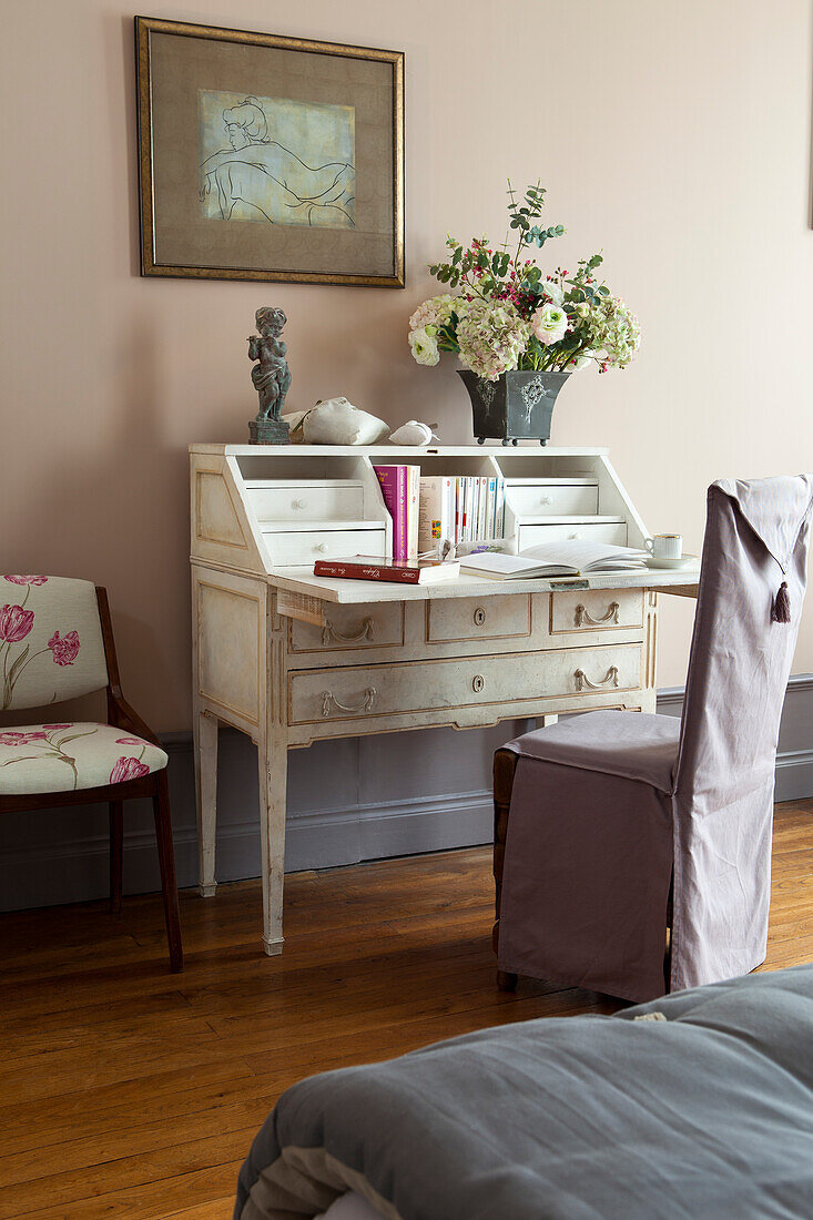 Antique writing desk and chair with lilac loose cover in elegant bedroom