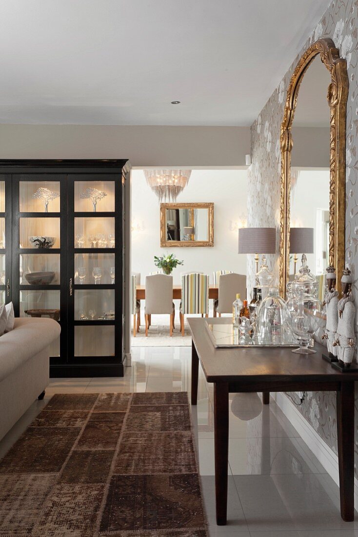 View past Illuminated display case and mini-bar into classic dining room