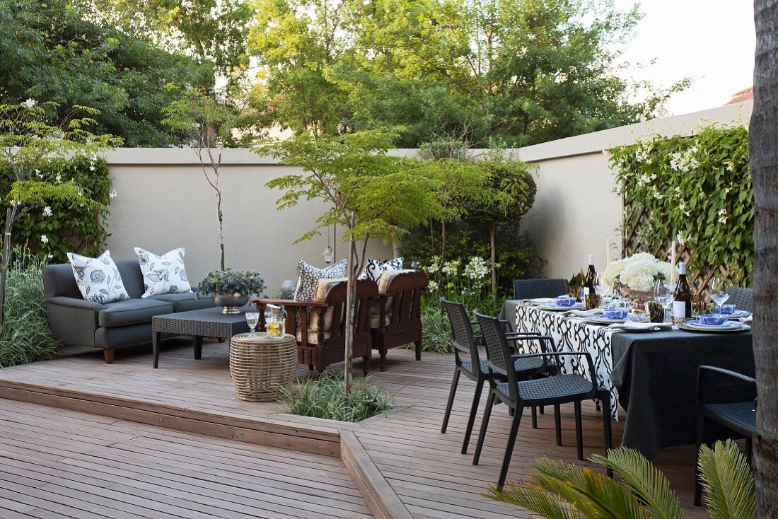Terrasse im Innenhof mit gedecktem Tisch und Lounge-Bereich