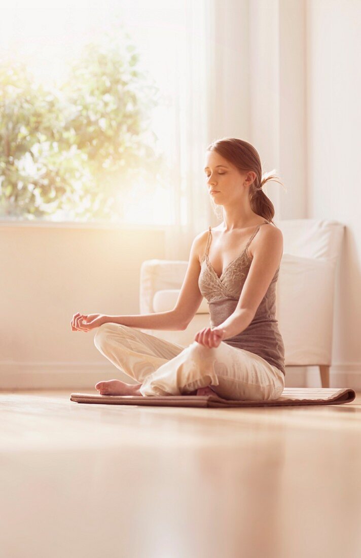 Young woman sitting in Lotus Position