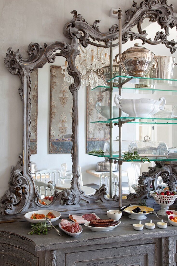 Antique dresser with buffet arranged in front of mirror