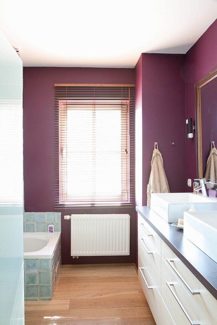 Elegant bathroom with white washstand and purple walls