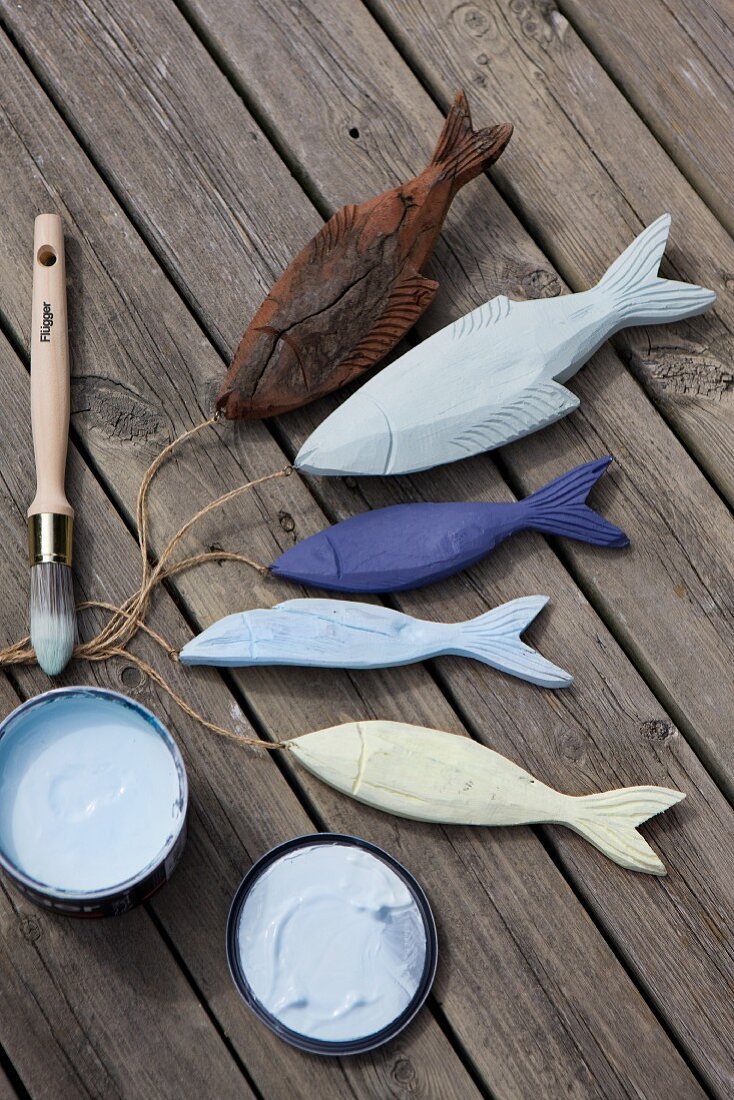 Hand-painted, carved wooden fish as maritime decorations