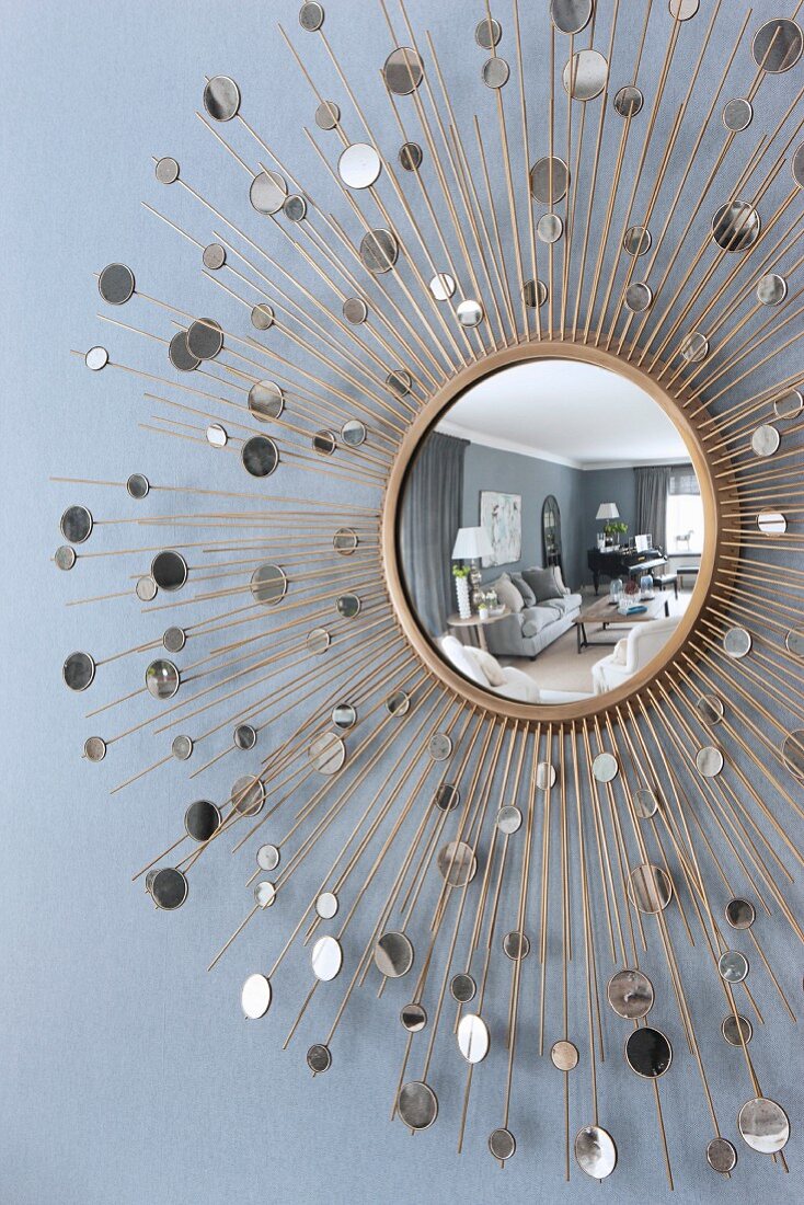 Round mirror reflecting elegant interior
