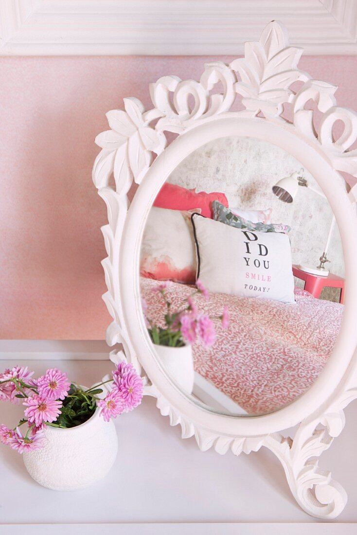 White vintage mirror with ornate frame on dressing table