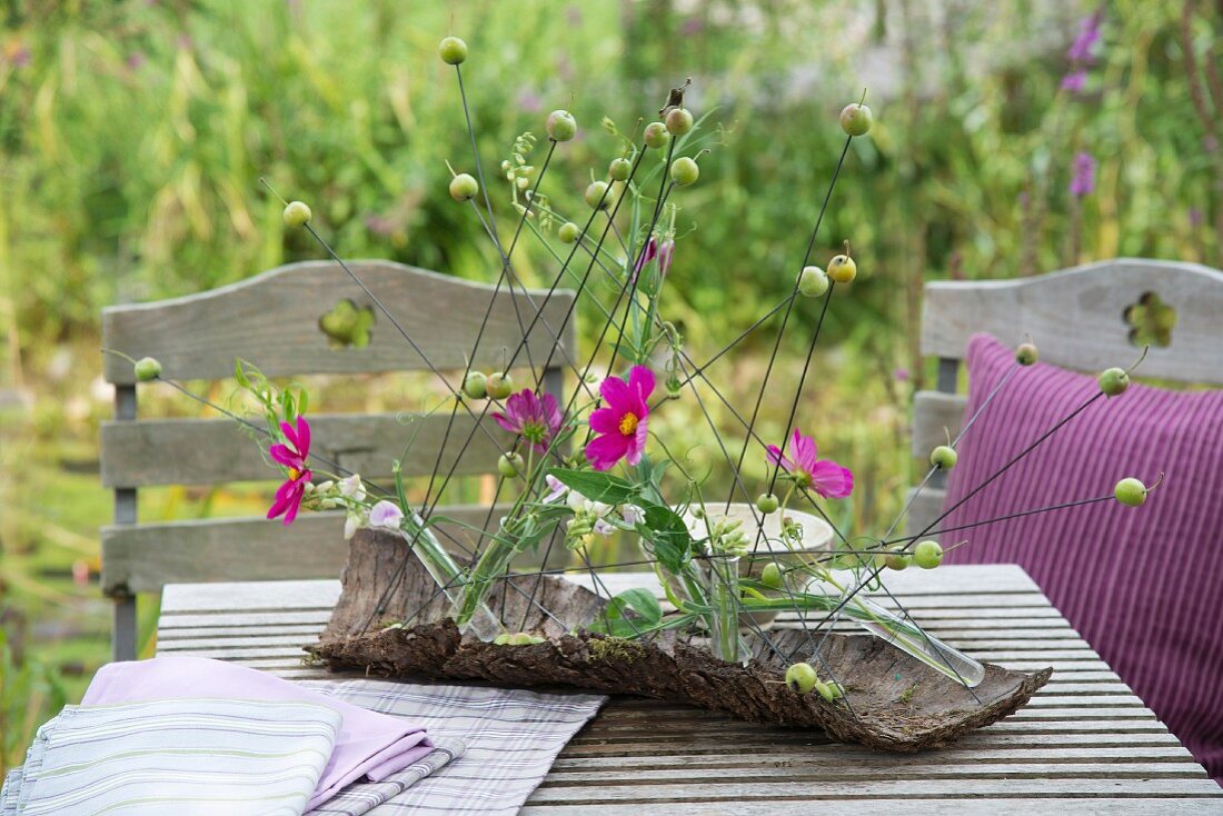 Cosmos arranged in piece of park as table centrepiece
