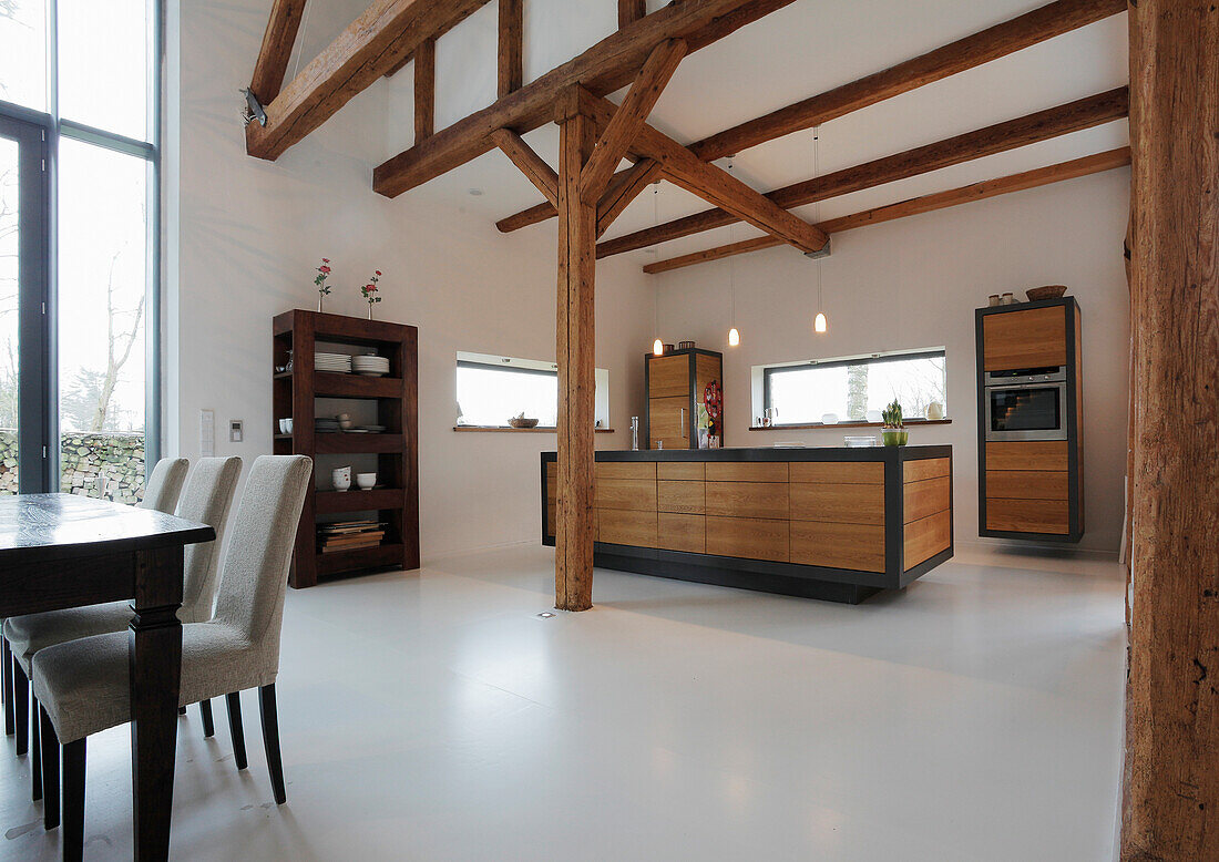 Modern kitchen-dining area with exposed beams