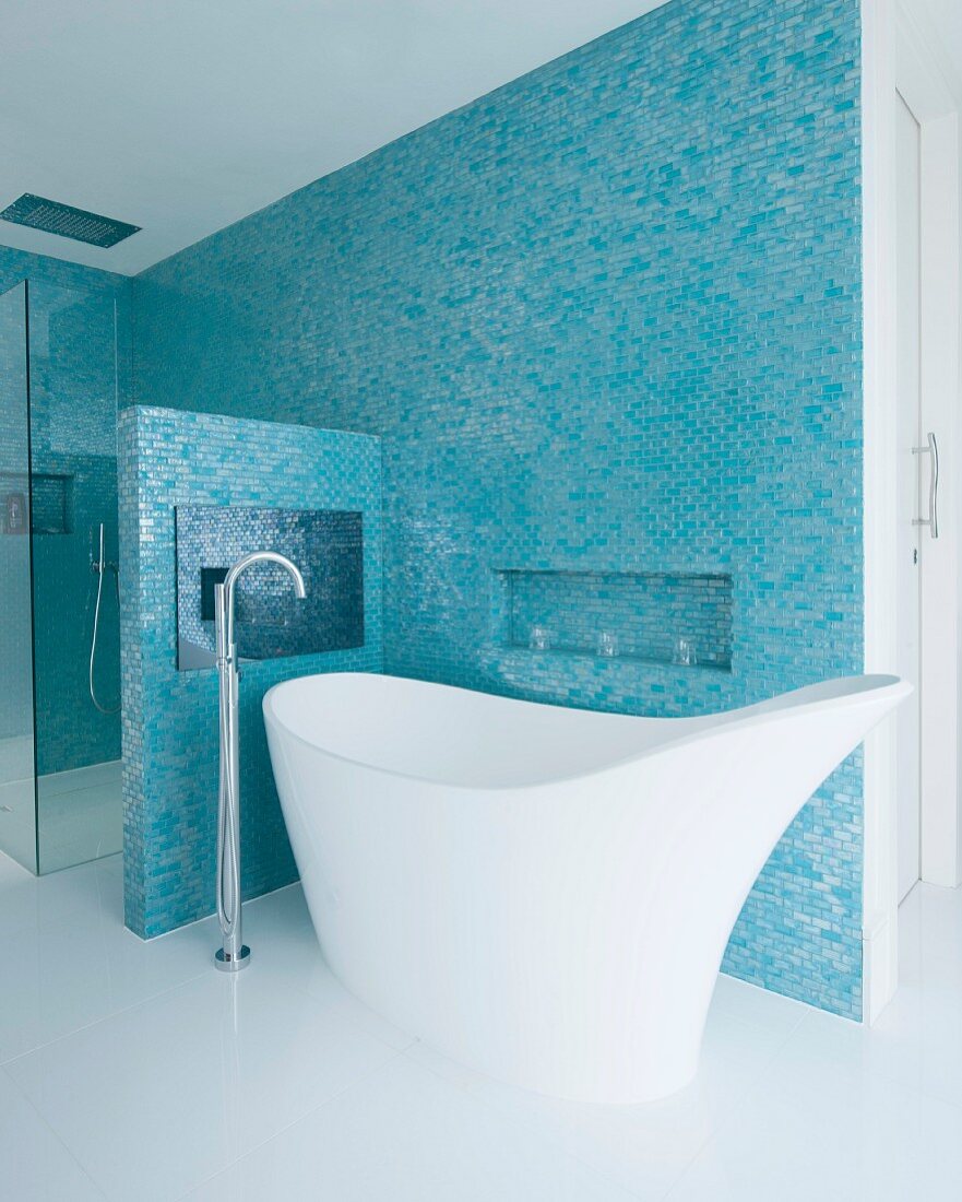 Unusual designer bathtub and floor-mounted taps in elegant bathroom