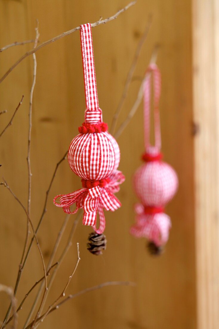 Christmas decorations made from polystyrene balls covered in ribbons, pompoms & pine cones