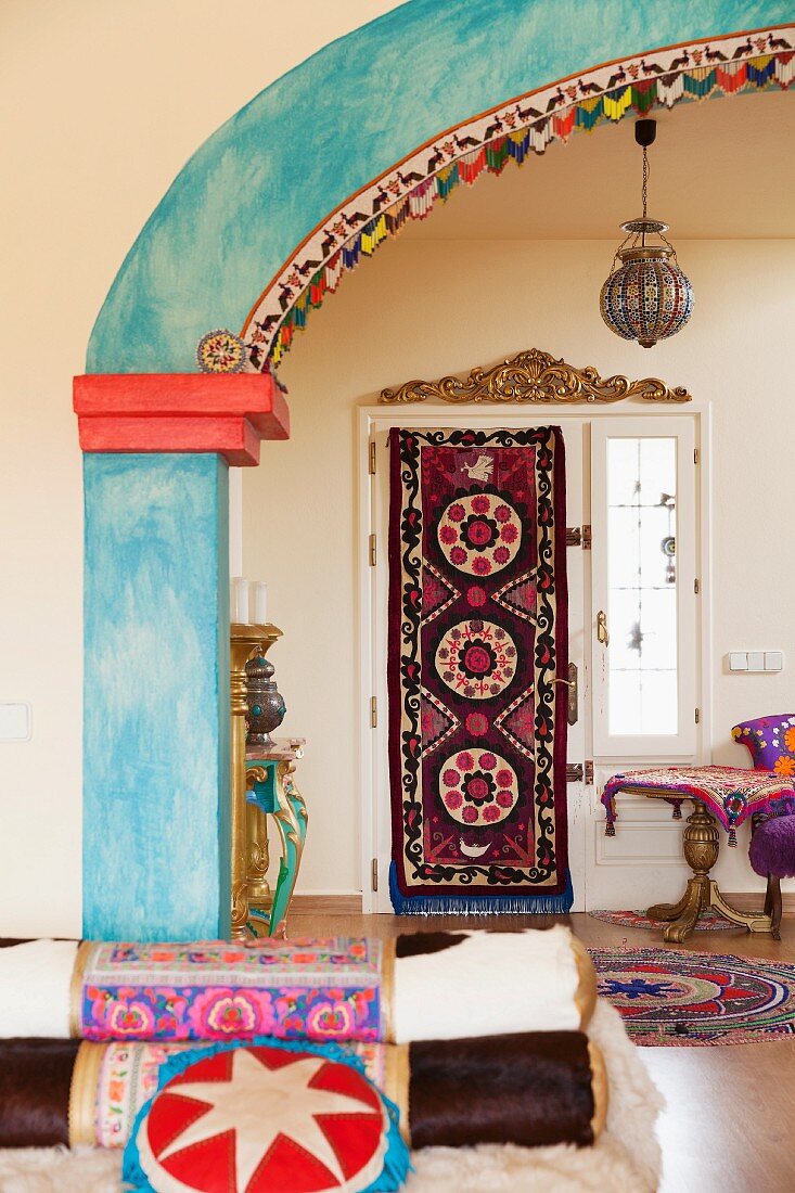 View of ethnic-style foyer through brightly painted archway