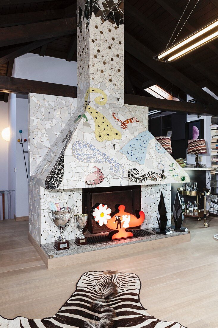 Fireplace artistically decorated with colourful tiles