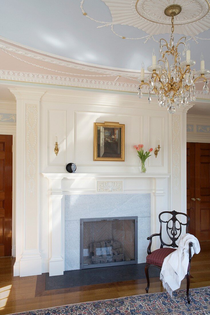 Grand interior with fireplace, chandelier and stucco ceiling rose