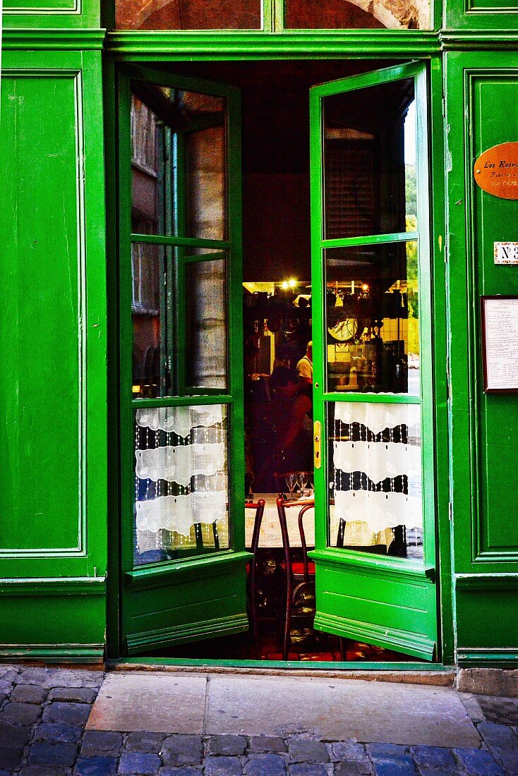 Green-painted front door of restaurant