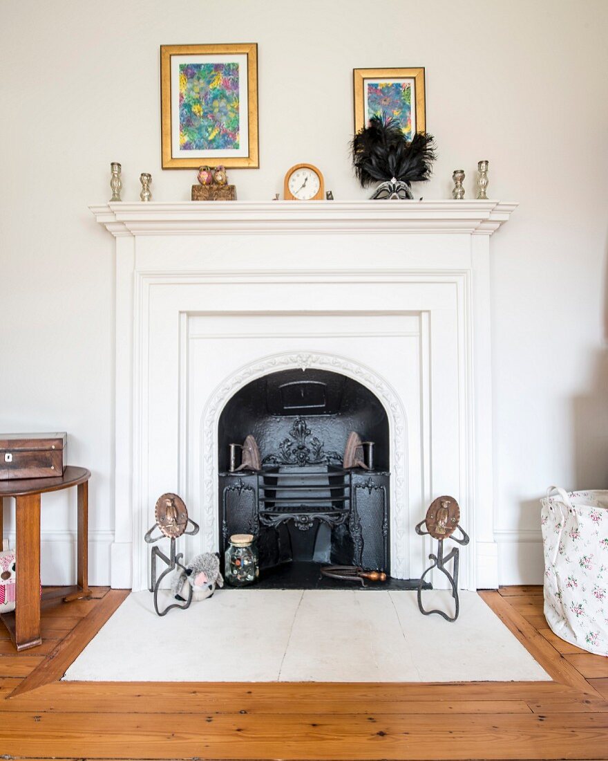 Open fireplace with white-painted surround and mantelpiece