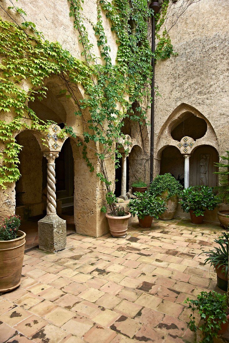 Innenhof der italienischen Villa Cimbrone, mit berankten Arkaden, Pflanzentöpfe auf Terrakottaboden