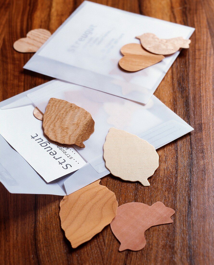 Small leaves and birds cut out of chip wood