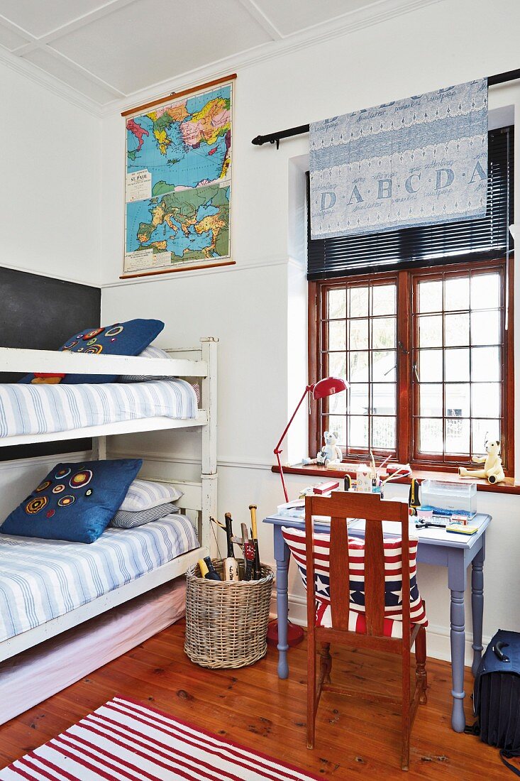 Bunk beds and stars and stripes cushion on chair below window