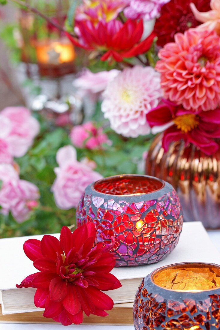Glasteelichter & Dahlienblüten auf Terrassentisch
