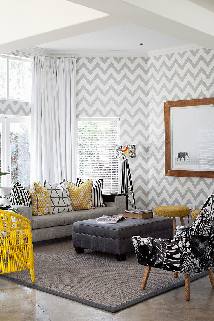 Living room with chevron wallpaper and yellow accents