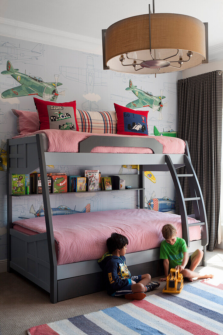 Children's room with bunk bed and aeroplane themed wallpaper