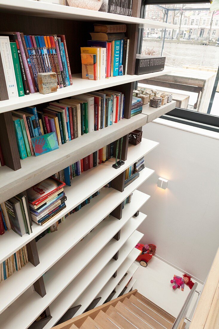 Modern bookcase along stairwell wall