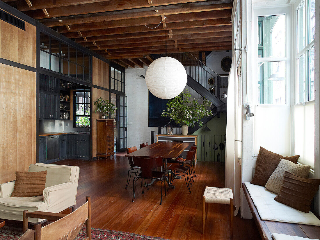 Open-plan interior of loft apartment with various wooden elements