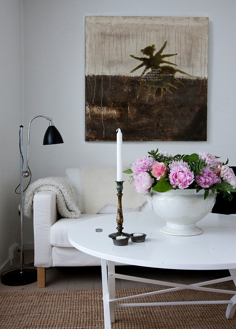 Bouquet of peonies in soup tureen on coffee table