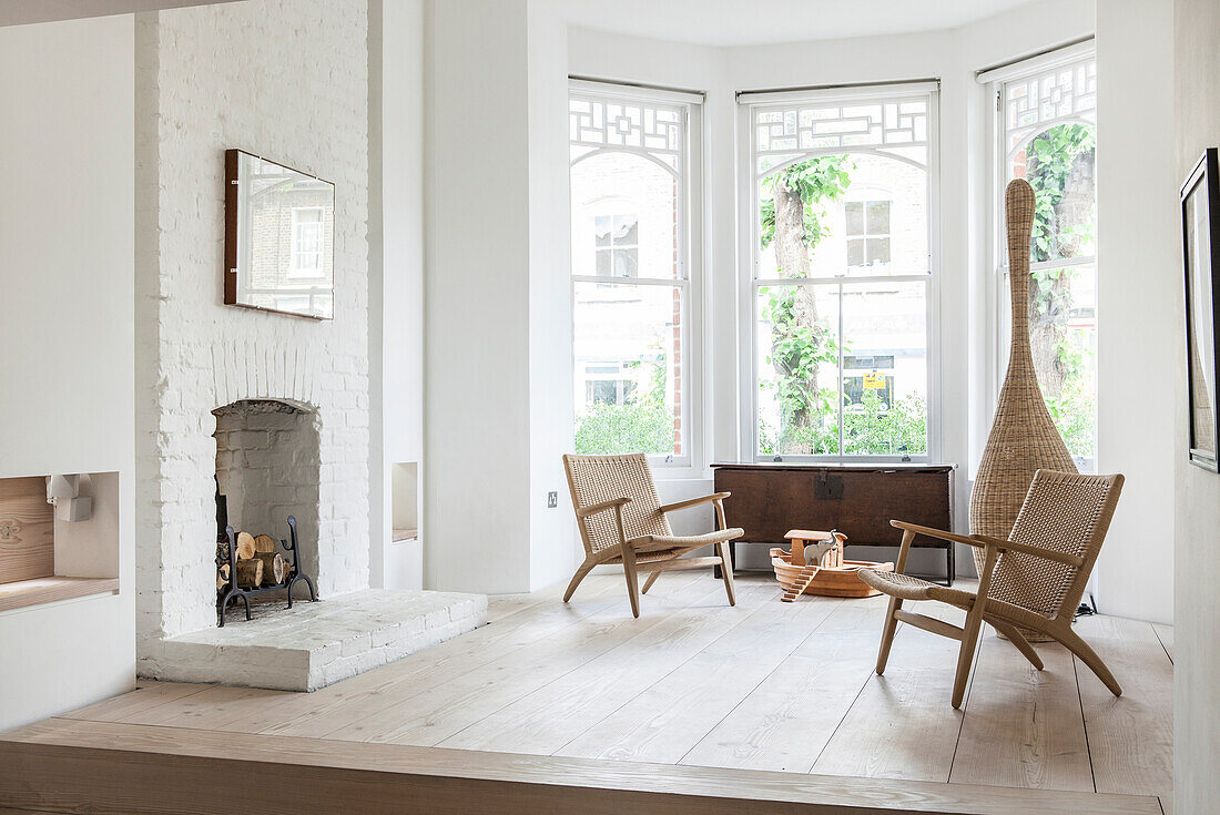 Open fireplace in living area on platform in window bay