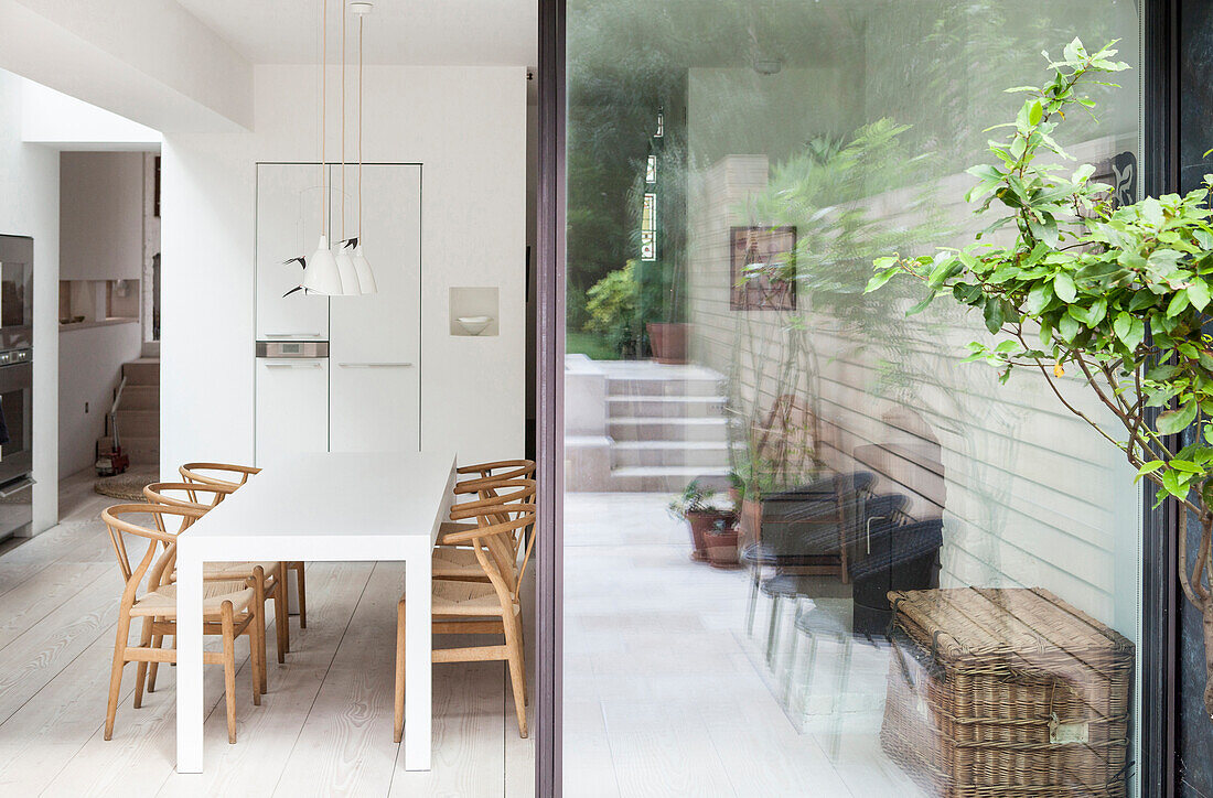 View from outside into dining room with designer chairs