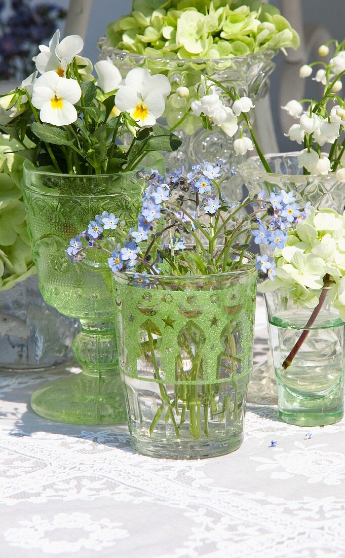Arrangement of various spring flowers in glass vessels