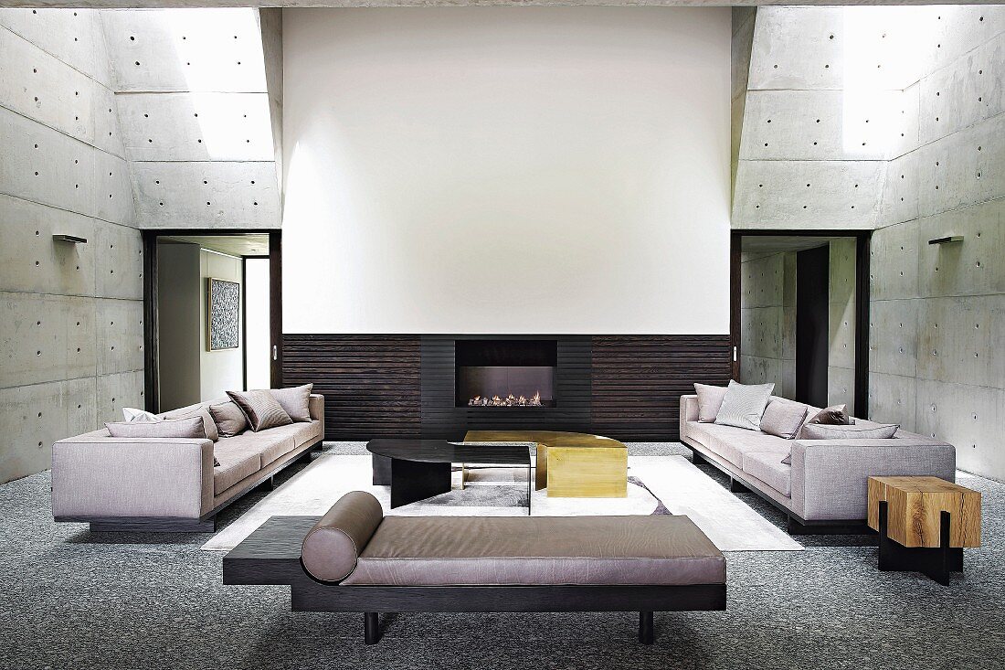 Modern double-height living room with concrete walls