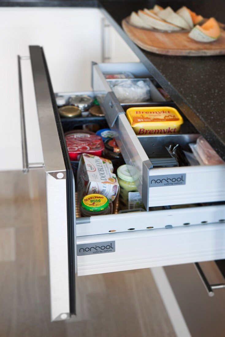 Open kitchen drawer with hidden interior drawer and practical dividers