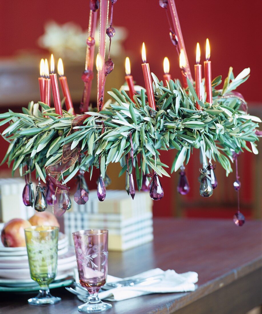 Suspended Advent wreath of olive branches decorated with glass droplets