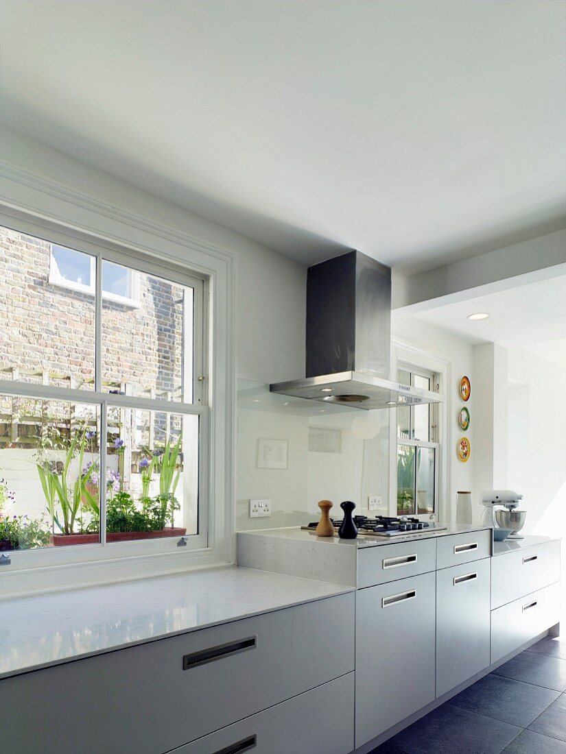 Bright kitchen with raised hob beneath extractor hood