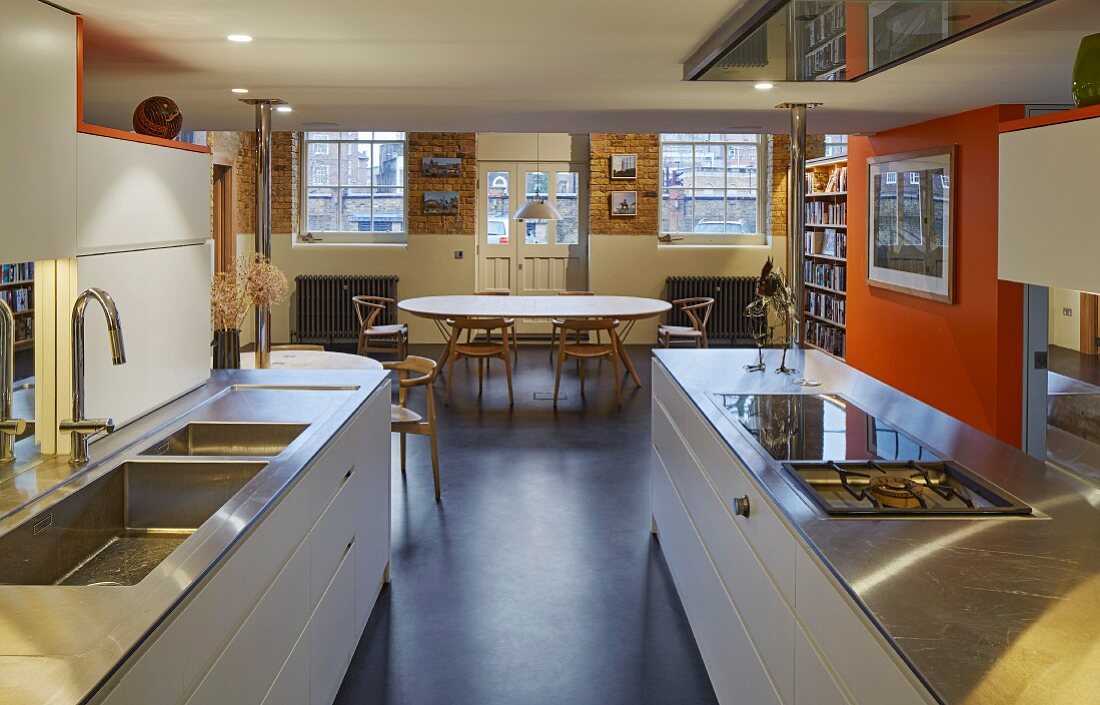 Open-plan kitchen with orange partition wall and black floor