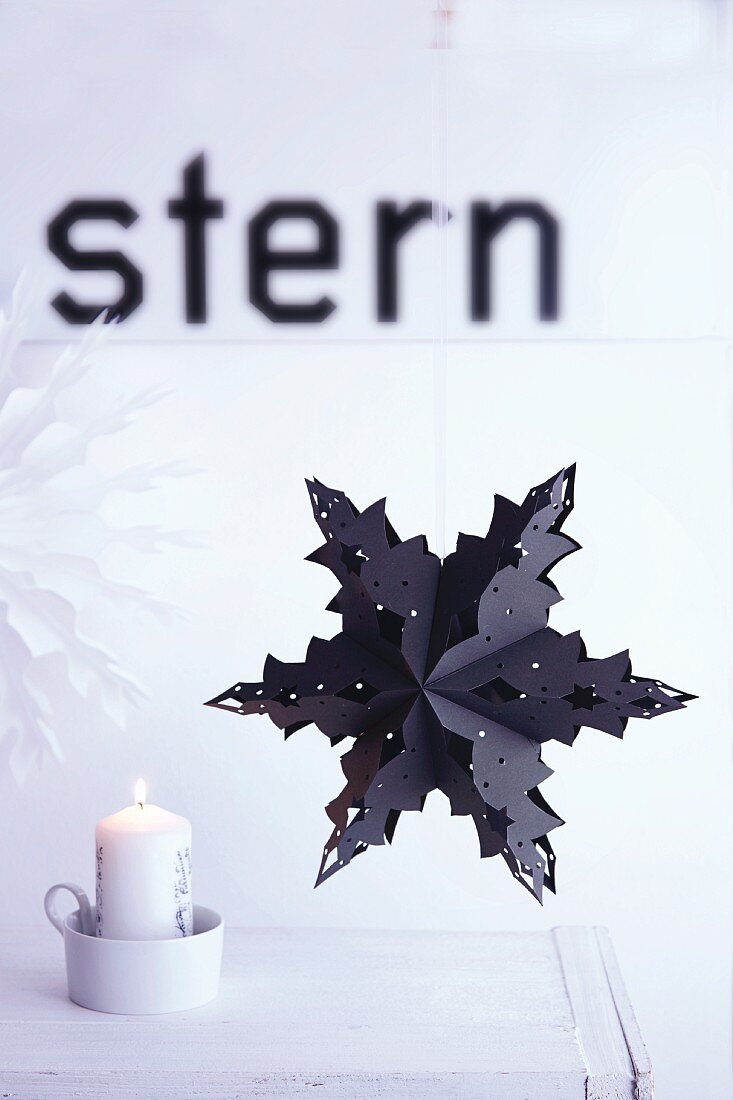 A paper cut-out folded into a Christmas star