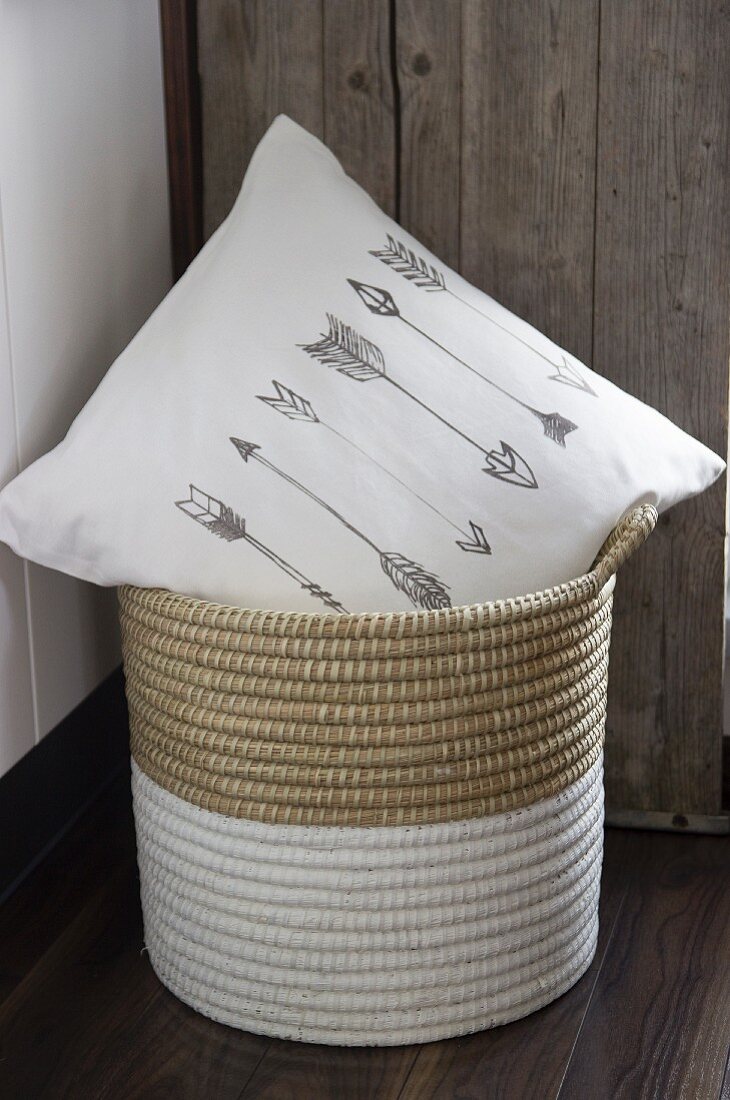White scatter cushion printed with arrow motifs in dip-dyed basket