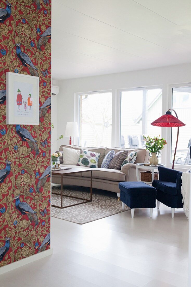Peacock-patterned wallpaper in bright vintage living room