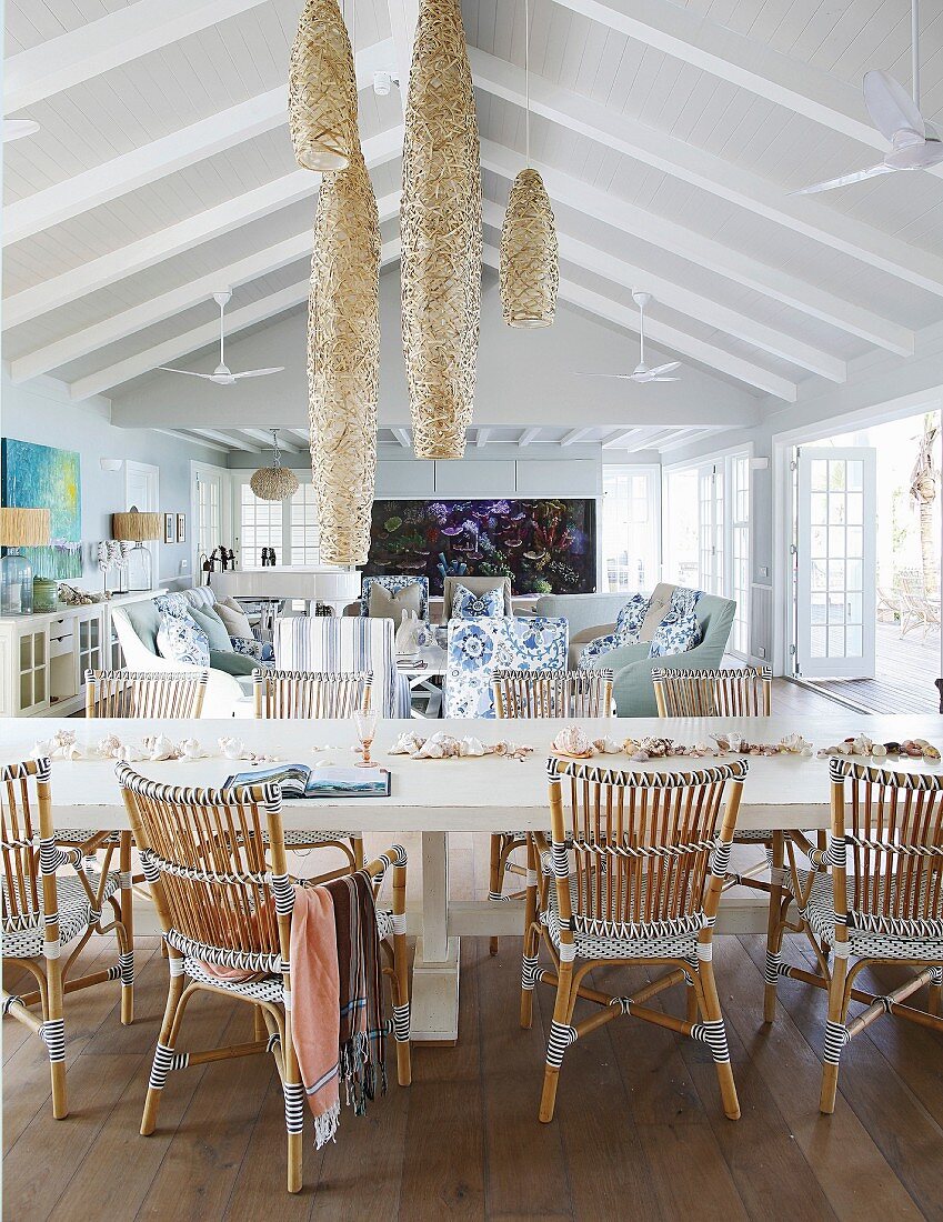 Long dining table and rattan chairs in beach house