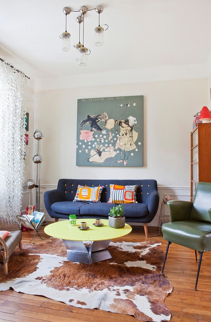 Retro furniture and cowhide rug in living room