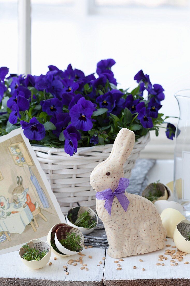 Easter bunny amongst egg halves, newspaper and cress
