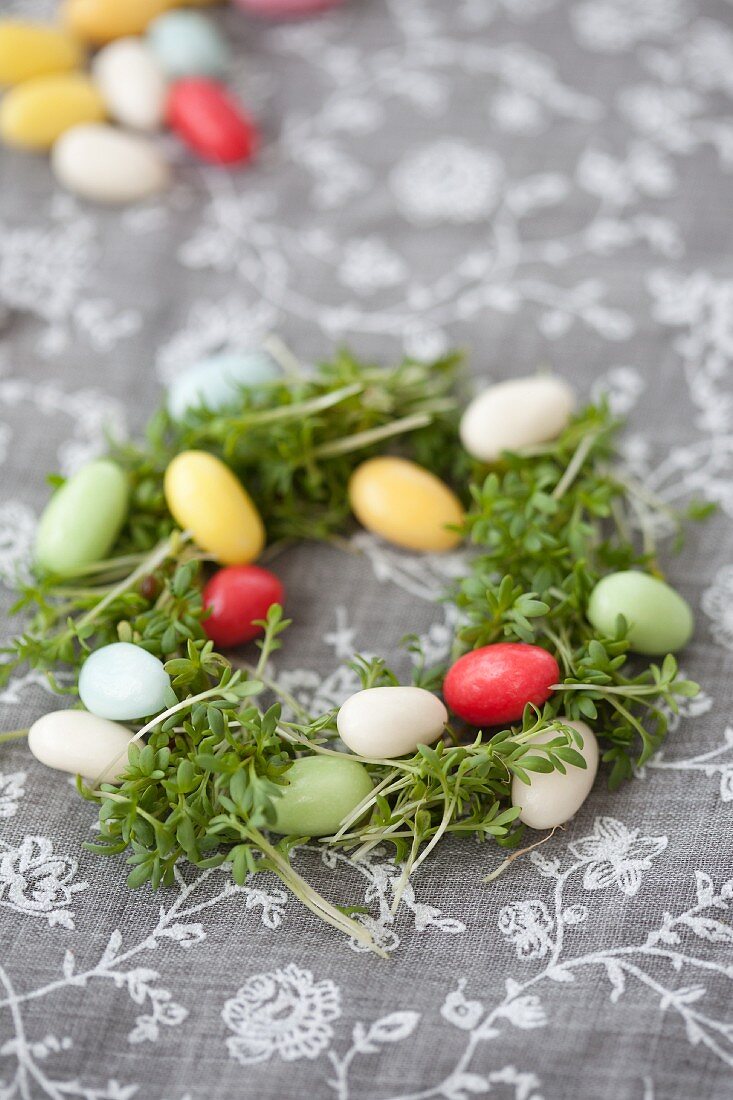 Small nest of cress and colourful sugar eggs