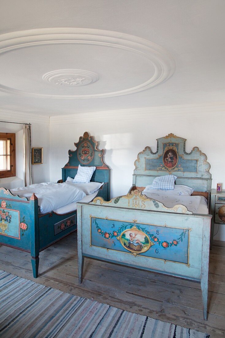 Traditional wooden twin beds in historical farmhouse
