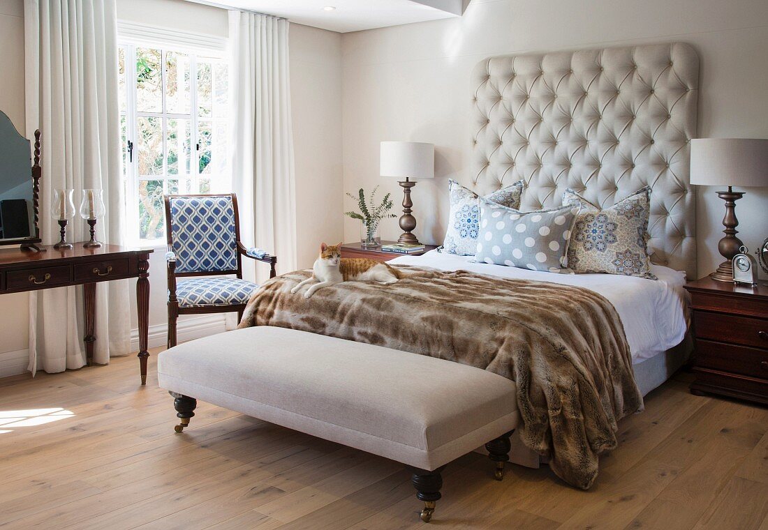 Classic bedroom with bedroom bench and button-tufted headboard