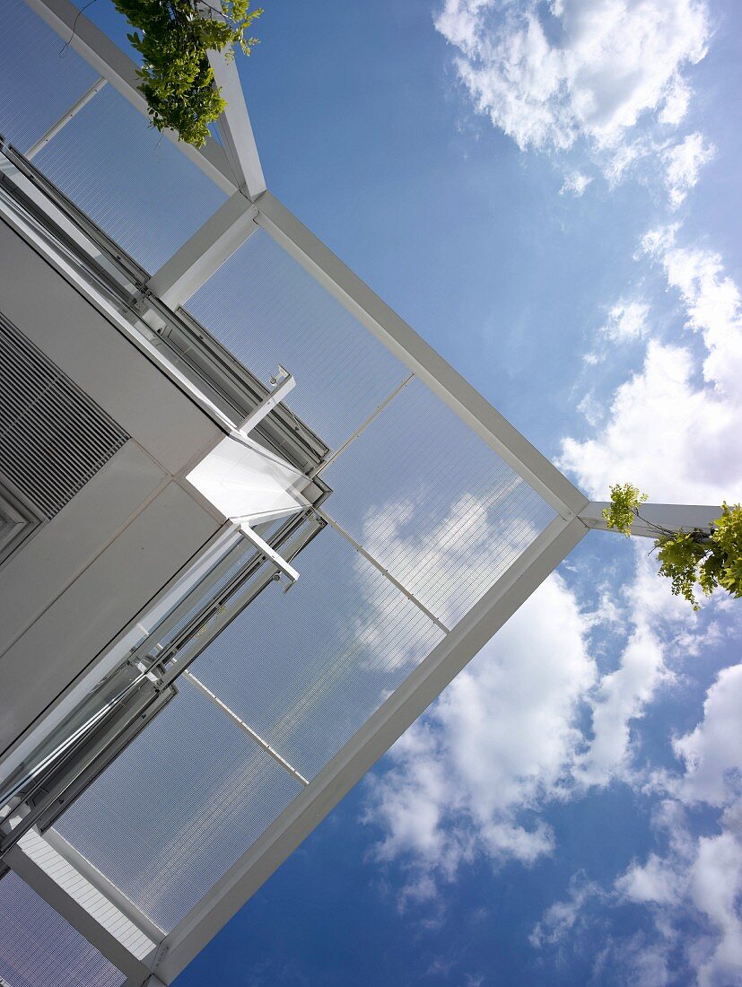 View of modern house and blue sky from below