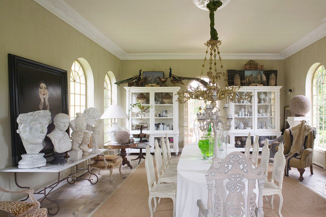 Long dining table and collection of busts in grand dining room